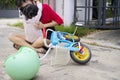 Child getting hurt while riding a bicycle. Mother helping her little daughter Royalty Free Stock Photo