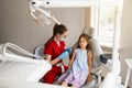 Child girl afraid dentist. Childrens dentist consults frightened kid in dentistry. Treatment of teeth and toothache in Royalty Free Stock Photo