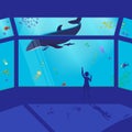 Child girl in the aquarium shows on a floating whale. Royalty Free Stock Photo