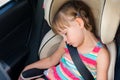 Child girl asleep in a car