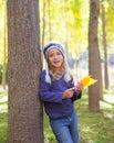 Child girl in autumn poplar forest yellow fall leaves in hand