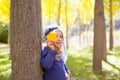 Child girl in autumn poplar forest yellow fall leaves in hand