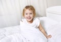 Child girl in bed smiling face..Toddler morning wake up.Caucasian little kid portrait Royalty Free Stock Photo