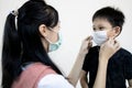 Child girl or big sister is wearing medical mask to prevent disease and flu for little brother during back to school,semester Royalty Free Stock Photo