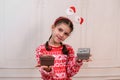 Child girl with boxes of gifts for the new year. A teenage girl holding two boxes with gifts. studio photo.