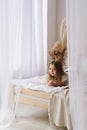 Child girl in a bright interior morning lifestyle dreaming