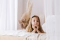 Child girl in a bright interior morning lifestyle dreaming