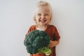 Child girl with broccoli healthy food vegan eating lifestyle organic vegetables plant based diet Royalty Free Stock Photo