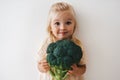 Child girl with broccoli organic vegetable food healthy lifestyle vegan menu plant based diet Royalty Free Stock Photo