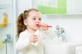 Child girl brushing teeth in bathroom Royalty Free Stock Photo