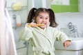 Child girl brushing teeth in bathroom Royalty Free Stock Photo