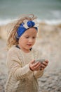 Child girl building stone tower on the beach Royalty Free Stock Photo