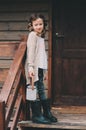 Child girl with candle holder relaxing in evening at cozy country house. Royalty Free Stock Photo