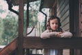 Child girl with candle holder relaxing in evening at cozy country house. Royalty Free Stock Photo