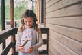 Child girl with candle holder relaxing in evening at cozy country house. Royalty Free Stock Photo