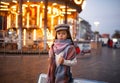 Child girl is standing at the street against background of evening city lights. Royalty Free Stock Photo