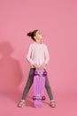 child girl with chewing gum holding skateboard Royalty Free Stock Photo
