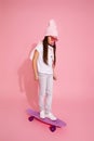 child girl with chewing gum on skateboard Royalty Free Stock Photo