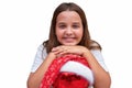 Child girl with christmas ornament in santa hat isolated in white Royalty Free Stock Photo