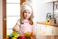 Child girl cooking at kitchen