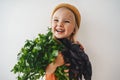 Child girl with coriander and basil bunch healthy vegan food organic harvest gardening plant based die