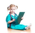 Child girl doctor writing to clipboard