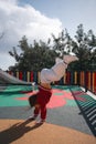 Child girl doing handstand on the outdoors playground. Funny active exercise Royalty Free Stock Photo