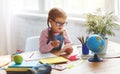 Child girl doing homework writing and reading at home Royalty Free Stock Photo