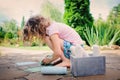 Child girl drawing with chalks in summer Royalty Free Stock Photo