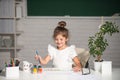 Child girl drawing with coloring pens paintind. Portrait of adorable little girl smiling happily while enjoying art and