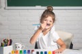 Child girl drawing with coloring pens paintind. Portrait of adorable little girl smiling happily while enjoying art and