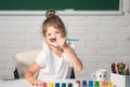 Child girl drawing with coloring pens paintind. Portrait of adorable little girl smiling happily while enjoying art and