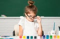 Child girl drawing with coloring pens paintind. Portrait of adorable little girl smiling happily while enjoying art and