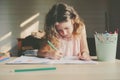 Child girl drawing at home with pencils Royalty Free Stock Photo