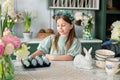 Child Girl in dress with Easter eggs at home. Portrait of happy little girl with bouquet flowers in kitchen. Smiling Girl is prepa Royalty Free Stock Photo