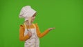 Child girl dressed like chef cook pointing at right on blank space place for your advertisement logo Royalty Free Stock Photo