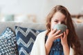 child girl drinking hot tea to recover from flu Royalty Free Stock Photo