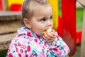 Child girl eating an apple in a park Royalty Free Stock Photo