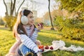 Child girl eating fresh red apples in sunny autumn park Royalty Free Stock Photo