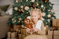 Child girl eating iced sugar cookies under Christmas tree Waiting for Christmas. Royalty Free Stock Photo