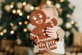 Child girl eating iced sugar cookies under Christmas tree Waiting for Christmas. Royalty Free Stock Photo