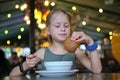 Child girl eating soup and tasty burger in restaurant Royalty Free Stock Photo