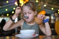 Child girl eating soup and tasty burger in restaurant Royalty Free Stock Photo