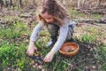 Child girl exploring nature in early spring forest. Kids learning to love nature. Teaching children about seasons changing. Royalty Free Stock Photo