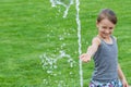 Child girl and fountain water stream; shot with copyspace