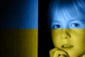 A child, a girl frightened looks out of the door. The concept of the Ukrainian crisis,