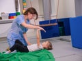 Child girl give five physiotherapist during sensory integration session Royalty Free Stock Photo