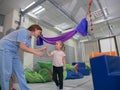 Child girl give five physiotherapist during sensory integration session Royalty Free Stock Photo