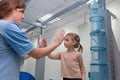 Child girl give five physiotherapist during sensory integration session Royalty Free Stock Photo