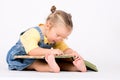 Child girl with glasses reading book on white. Royalty Free Stock Photo